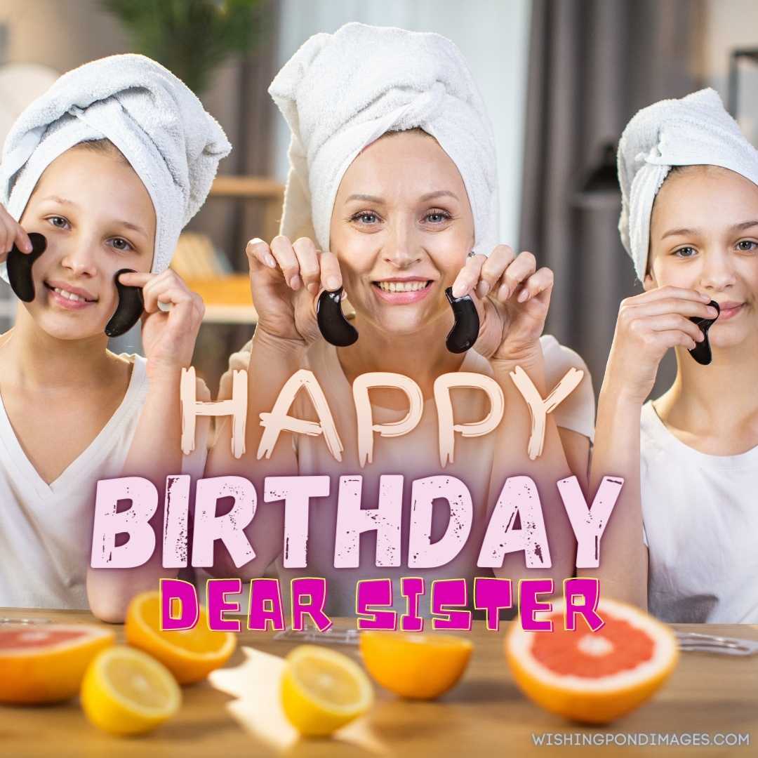 Caring sister with two little sisters smiling and looking at the camera while holding black collagen
